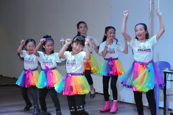 A group of young girls dancing AI-generated content may be incorrect.